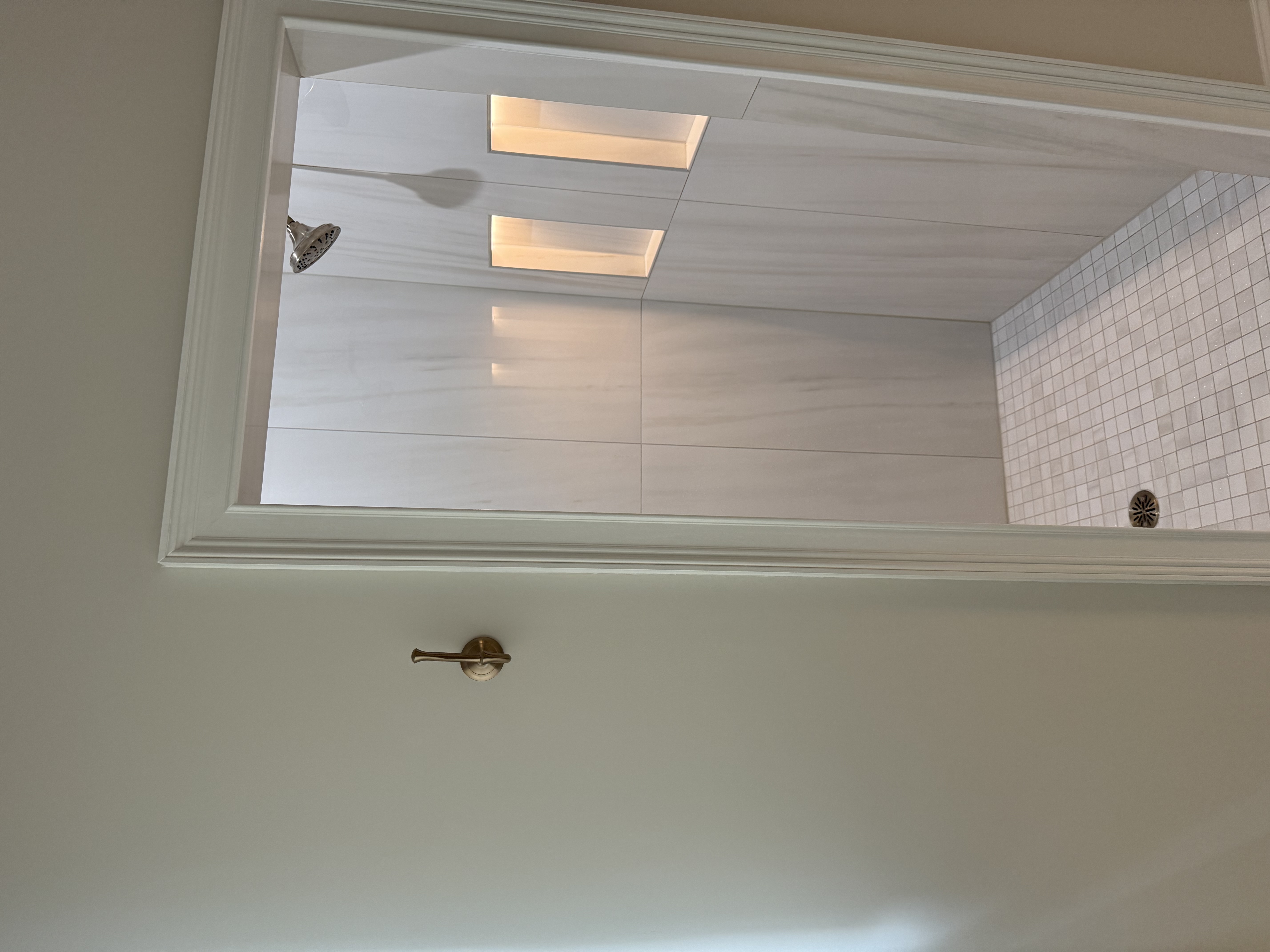 Five Forks master bathroom before remodel — detail of original tile flooring and tub surround in Simpsonville SC